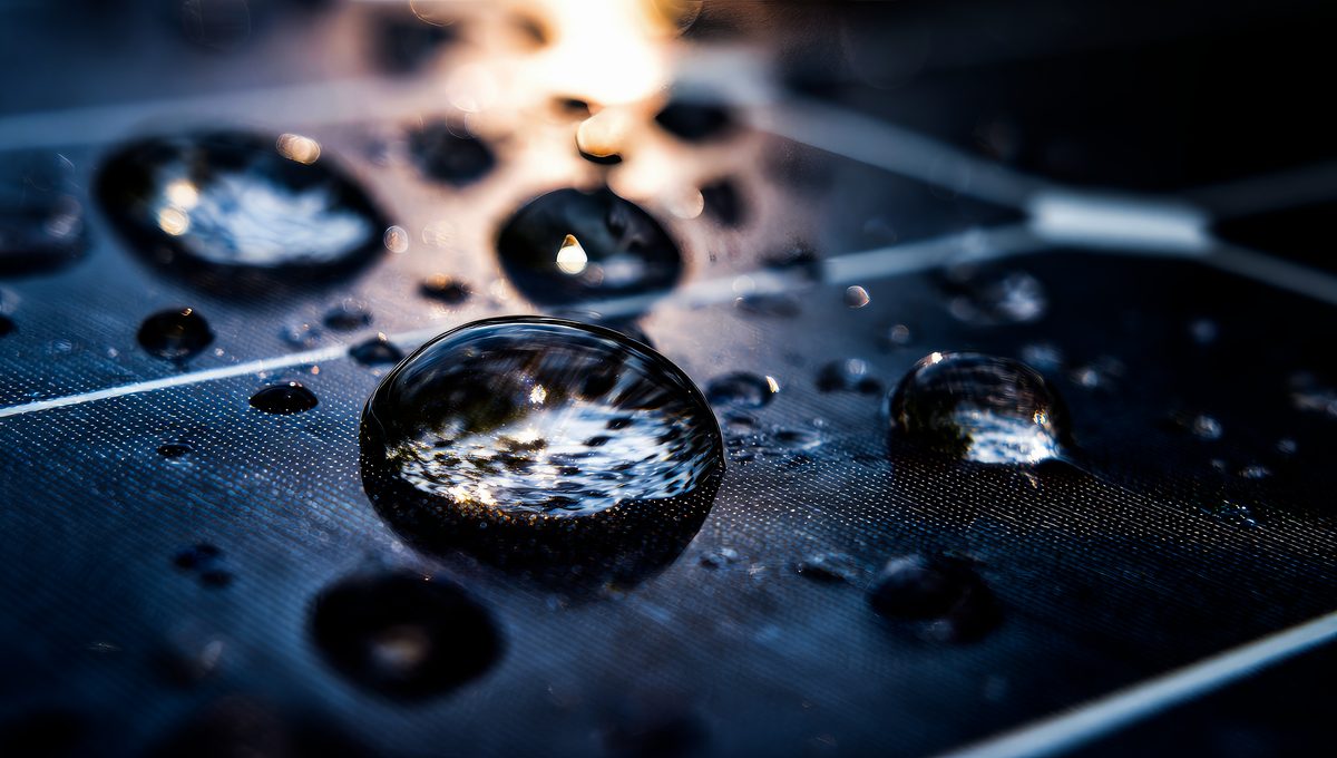 Close-up of water droplets on the glass of a solar panel